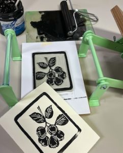 Linocut Print and Plate displayed in printing press